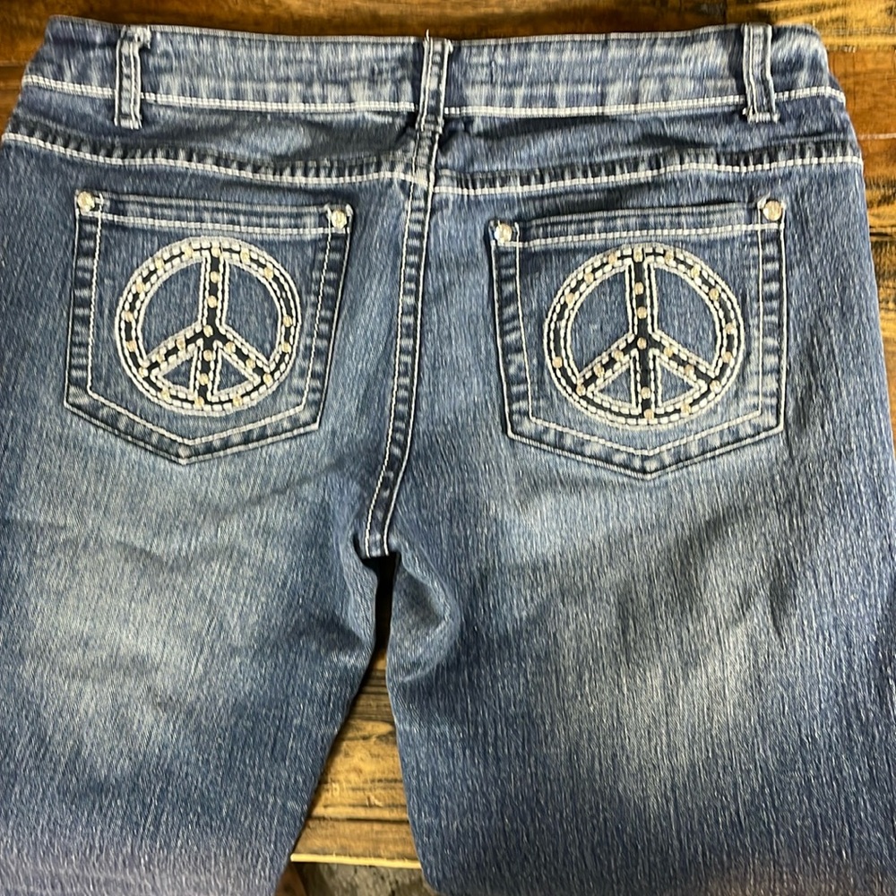 Women's rhinestone bling Peace sign Denim Shorts fits size 10 well.  Super cute!
